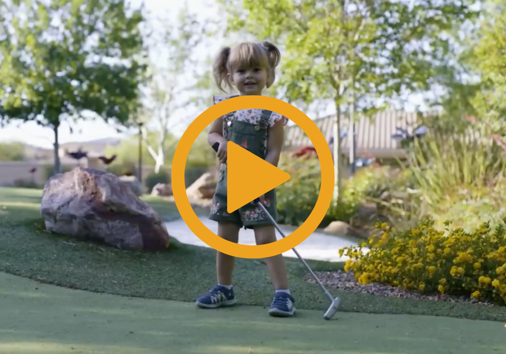 girl playing mini golf, video icon on top