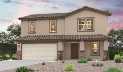 A two-story beige house with a tiled roof, two-car garage, and desert landscaping in front, set against a colorful sunset sky.