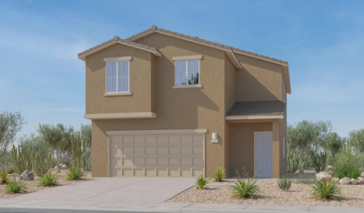Two-story tan stucco house with a double garage and front door to the right. The yard has desert landscaping with rocks and drought-tolerant plants. Blue sky in the background.