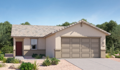 Single-story beige house with a two-car garage, red front door, small window, and desert landscaping featuring gravel and drought-tolerant plants; trees and blue sky in the background.