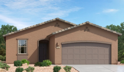 A single-story, modern stucco house with a two-car garage, brown exterior, tile roof, and small desert landscaping in the front yard against a blue sky.