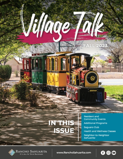A colorful train with passengers rides along a tree-lined path on the cover of "Village Talk" Fall 2023 magazine, featuring headlines about community events and programs in Rancho Sahuarita.