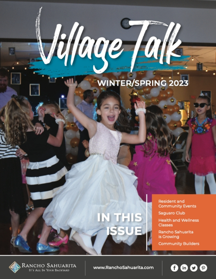 A young girl in a white dress dances joyfully at a community event with other children in the background. The text reads “Village Talk Winter/Spring 2023” and lists topics included in the issue. Rancho Sahuarita branding is at the bottom.