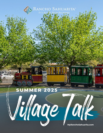 A colorful mini train with red, yellow, and green cars sits on a track near green trees under a blue sky. Text reads "Rancho Sahuarita Summer 2025 Village Talk.