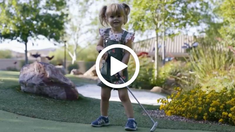 girl playing mini golf, video icon on top