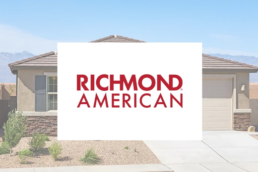 richmond-american-2026 Single-story house with a brown shingle roof and stone accents. Overlaid in the center is a white box with the red text “RICHMOND AMERICAN.” The driveway and desert landscaping are visible in front.
